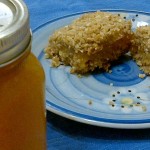 peach almond oat bars next to a jar of peach jam